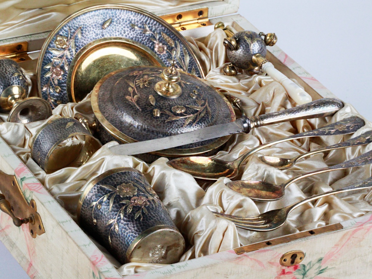 Christening set with the coats of arms of the Habsbourg Imperial court in gilded sterling silver with floral ornaments. The set includes 8 pieces finely chiseled.
