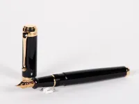 Aurora Talentum fountain pen, black lacquer with gold trim, shown open and capped; SKU IB02704.