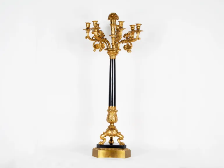 IB01242, Pierre-Philippe Thomire candelabrum in gilded bronze with eight lights, black marble stem and base, shown full length on a white background.