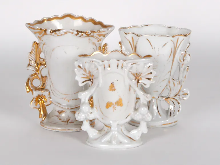 IB02435: Three white and gilt openwork porcelain vases with handles, shown together on a white background.