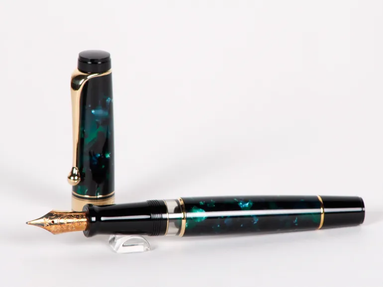 Aurora Optima fountain pen, emerald green and black with gold trim and 14K nib, SKU IB02690.