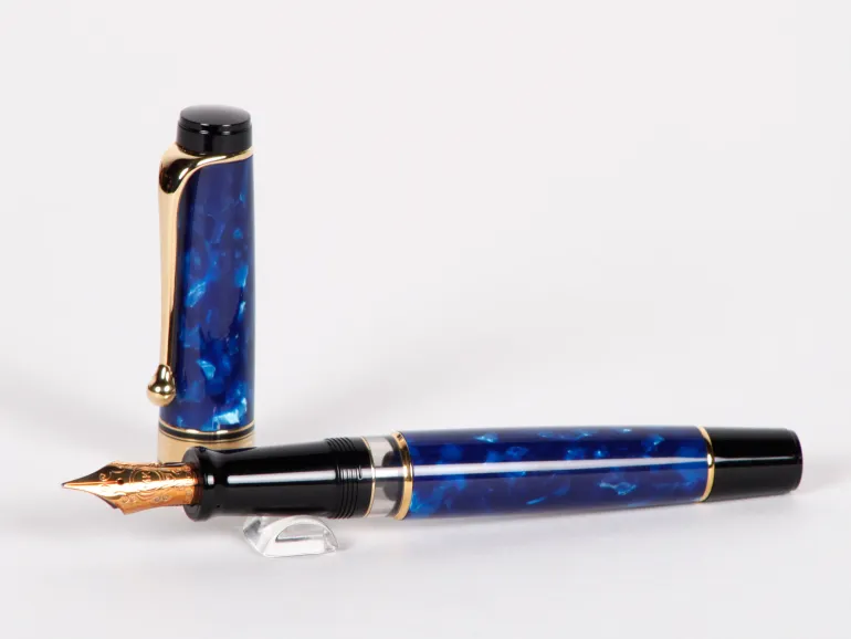 Stylo plume Aurora Optima bleu, SKU IB02695, avec finitions dorées et plume 14 cts sur fond blanc.