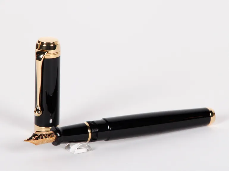 Aurora Talentum fountain pen, SKU IB02706, black lacquer with gold trim and 14K gold nib shown in black and gold.