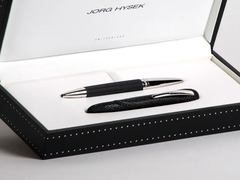 Jorg Hysek Pens IB02898 ball pen in black presentation box, with silver-toned ends and a black textured case.