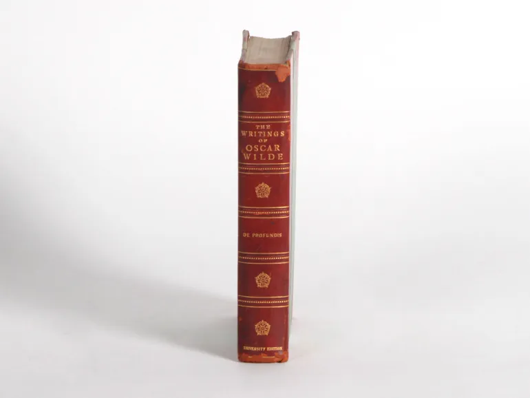 IB06440: ظهر كتاب بغلاف جلدي أحمر بعنوان The Writings of Oscar Wilde، De Profundis، Uniform Edition، مع تآكل عند الحافة العلوية والسفلية.
