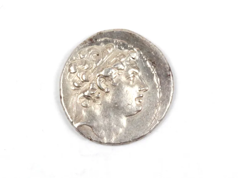 Silver tetradrachm coin of Antiochus IV Theos Epiphanes, obverse with crowned head visible, SKU IB08954.