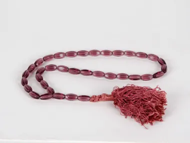 IB03620 Masbaha rosary with 33 amethyst-colored glass beads and a braided thread tassel.