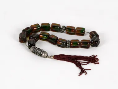 IB03655 Masbaha rosary with brown glass beads, green reflections, a copper pendant and burgundy tassel.
