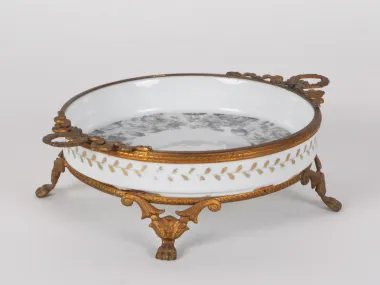 Sèvres IB04674 porcelain and bronze centerpiece with gilded claw-foot base, shown in white with floral decoration.