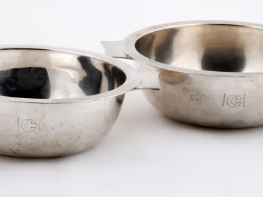 SKU IB04725, Christofle pair of two-handled silver-plated metal bowls, shown side by side on a white background.
