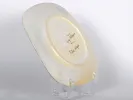 SKU IB01061: underside of a square ceramic plate signed Guy Trevoux, shown on a clear stand.