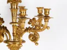 IB01242, Pierre-Philippe Thomire gilded bronze candelabrum with multiple candle cups and floral scroll arms, shown in close-up.