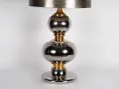 IB01916 ceramic lamp base with two silver and gold spheres and a silver lampshade, circa 1960.