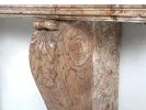 IB02044 Brocatelle marble console detail showing the carved leaf scroll support and rectangular top.