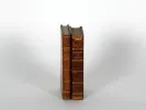 SKU IB02257: كتابان من القرن التاسع عشر مغلفان بالجلد، واقفان، مع ظهور ظهرين بنيين مهترئين وعناوين مذهبة.