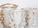 SKU IB02435: three white and gold openworked porcelain vases with handles, shown close up.