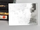 صفائح فوتوغرافية داخل علب سوداء، وتظهر صفيحة واحدة؛ SKU IB02512.