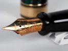 Aurora Optima fountain pen nib in close-up, gold 14K nib with black section, SKU IB02690.