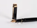 Aurora Talentum fountain pen, SKU IB02706, black lacquer with gold trim and gold nib, shown with cap and nib visible.