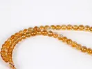 IB03618 Masbaha rosary with round natural topaz beads and a gold pendant, shown on a white background.