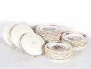 SKU IB03927: Obernai Sarreguemines earthenware table set with stacked plates and decorated soup and dessert plates.