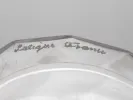 Lalique IB04063 vaporizer flask in clear faceted crystal, close-up of the signed rim with frosted sparrow motif.