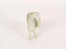 IB05076: Small pale jade figurine of a horse standing on three legs, shown on a plain background.
