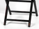 Hanbel IB05630 low folding wood table, close-up of dark carved wooden legs on a white background.