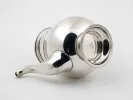 Christofle IB05792 Gallia silver-plated tea pot with wooden handle, shown on its side against a white background.