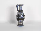IB06326: Blue and white Moroccan ceramic jug with one handle and silver filigree, shown on a plain background.