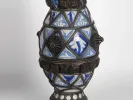 SKU IB06326: close-up of a blue and white ceramic Moroccan jug with silver filigree and dark metal bands, shown against a plain background.