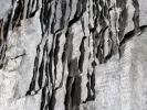 Claudie Hunzinger, IB07213: close-up of a grey mixed-media artwork with layered ash-like paper and faint text.
