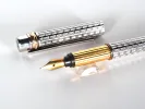 Cartier Trinity 3 fountain pen, SKU IB07755, with silver guilloché body and gold-plated trim; shown with cap and 18k nib.