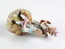 Meissen Porcelain IB08069: مجموعة خزفية من القرن التاسع عشر لفتى وفتاة مع مندولين، معروضة على قاعدة تشبه السلة.