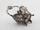 Victor Nuber sterling silver basket, SKU IB08127, with ornate pierced decoration, four feet and a glass insert.