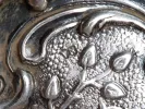 IB08127 Victor Nuber sterling silver basket, close-up of the floral chased silver surface and handle detail.