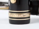 Montblanc Pens & Accessories IB08921 Meisterstuck 149 fountain pen close-up, black resin with gold trim and engraved band.