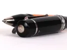 Delta roller pen IB08932, Dolcevita model, black resin with amber body and silver trim, shown close up on white background.