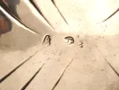 SKU IB09116: close-up of hallmarks stamped on an 18th-century Irish sterling silver sauceboat, showing the crowned harp, Hibernia mark and silversmith mark.