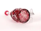 SKU IB09389: large red cut crystal carafe with lozenge and star patterns, shown on its side.