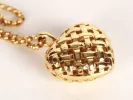 Tiffany & Co IB09737 gold woven heart pendant necklace, close-up of domed openwork heart on chain.